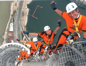 People climbing up mast at Macau Tower